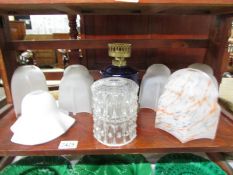 A quantity of vintage glass lamp shades.