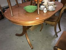 A teak extending dining table