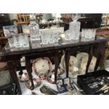 A glass topped coffee table with 2 matching small coffee table