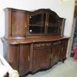 A large mahogany sideboard with glazed cupboard to top.