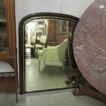 A Victorian arched top over mantel mirror.