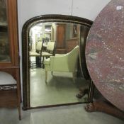 A Victorian arched top over mantel mirror.