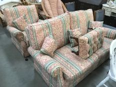 A 2 piece suite consisting of 2 seater settee and a matching chair