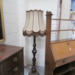 An old wooden standard lamp, shade a/f.