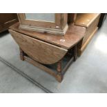 A small solid oak drop leaf table