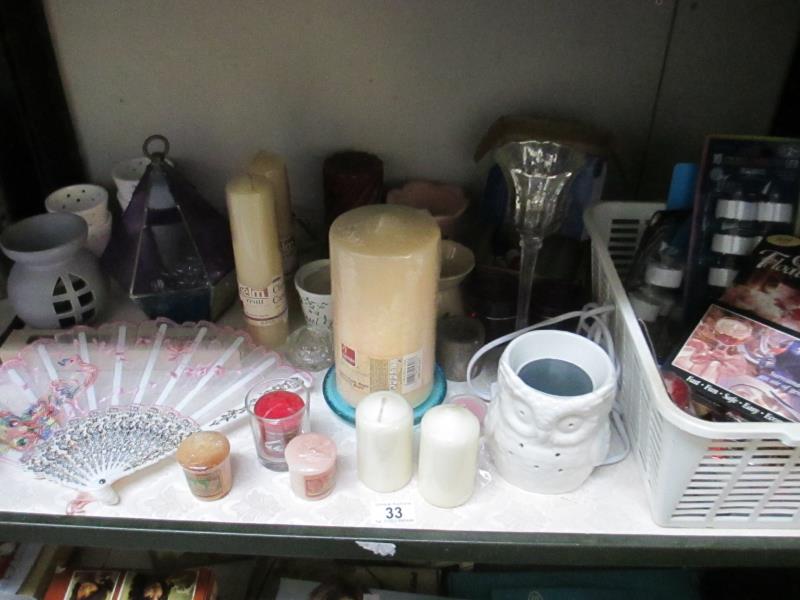 A quantity of candles and candlesticks/holders plus a boxed fan