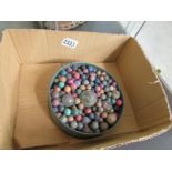 A large quantity of pre war clay marbles in flamingo tin.