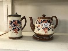 An Edwardian Imari patterned glazed teapot with stand and matching jug