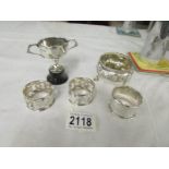 3 silver napkin rings and a silver salt approximately 110 grams together with a silver cup on