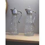 2 fine crystal carafes with silver plate lids spouts and handles