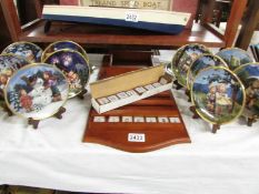 A vintage M J Hummel Seasons of Joy perpetual calendar, tiles, 12 plates and 11 stands.