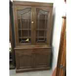 A dark oak dresser/bookcase with astragal glazed doors