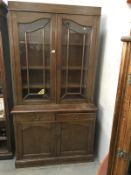 A dark oak dresser/bookcase with astragal glazed doors