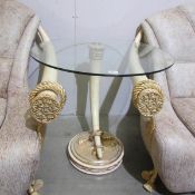 An imitation elephant tusk table with glass top.