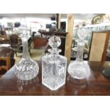 3 cut glass decanters including one etched.
