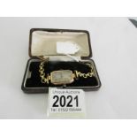 A ladies 9ct gold wrist watch on a rolled gold bracelet, in working order.