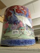 A large hand painted Chinese jardiniere depicting exotic birds and flowers.