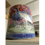 A large hand painted Chinese jardiniere depicting exotic birds and flowers.