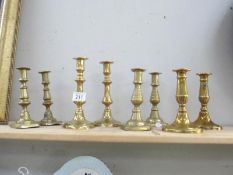 4 pairs of brass candlesticks