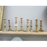 4 pairs of brass candlesticks