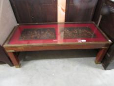 A mahogany and brass coffee table featuring 2 panels under glass depicting medieval knights.