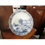 A large blue and white Delft charger.