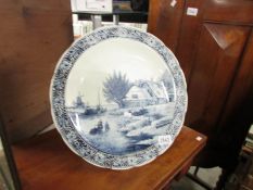 A large blue and white Delft charger.