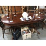 A dark wood stained extending dining table