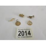 5 assorted 9ct gold charms, approximately 7 grams.