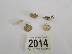 5 assorted 9ct gold charms, approximately 7 grams.