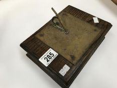 A cigarette box with brass sundial