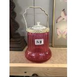 A cranberry glass biscuit barrel with silver plated fittings