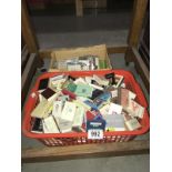 A box of assorted match boxes and books