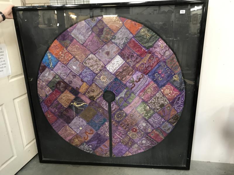 A large framed & glazed Eastern silk circular patchwork table cloth.