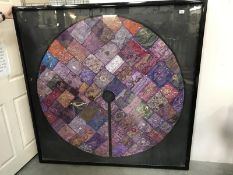 A large framed & glazed Eastern silk circular patchwork table cloth.