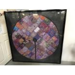 A large framed & glazed Eastern silk circular patchwork table cloth.