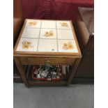 A tile topped oak side table with drawer