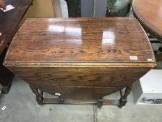 A 1930s oak gate leg table