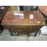 A 1930s oak gate leg table