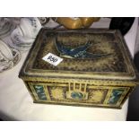 A vintage Blue Bird tin with contents of cigarette cards