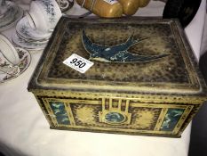 A vintage Blue Bird tin with contents of cigarette cards