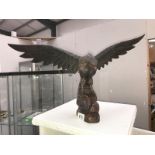 A large Black Forest style carved wooden eagle