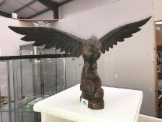 A large Black Forest style carved wooden eagle