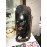 A carved tree stump of an African bust