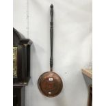 A Victorian copper bed warming pan