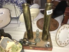A mixed lot including brass shell cases, vintage handcuffs,
