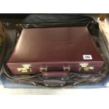 2 vintage luggage carriers including Samsonite and American Tourister and a briefcase