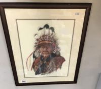 A framed & glazed tapestry of an Indian Chief