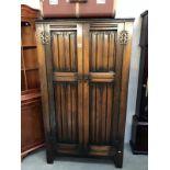 An oak double wardrobe with drapery carved doors