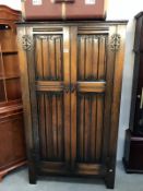 An oak double wardrobe with drapery carved doors